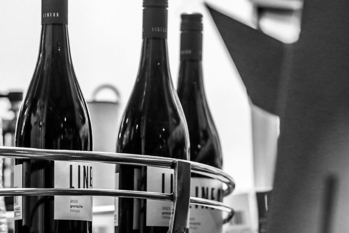 Black and white image of Linear wines during the bottling process.